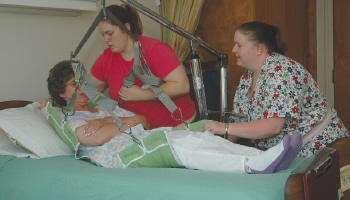 Staff assisting a resident with a lack of mobility.